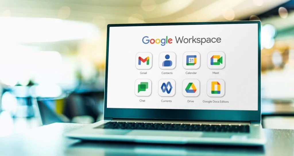 Google Workspace apps displayed on a laptop sitting on a desk